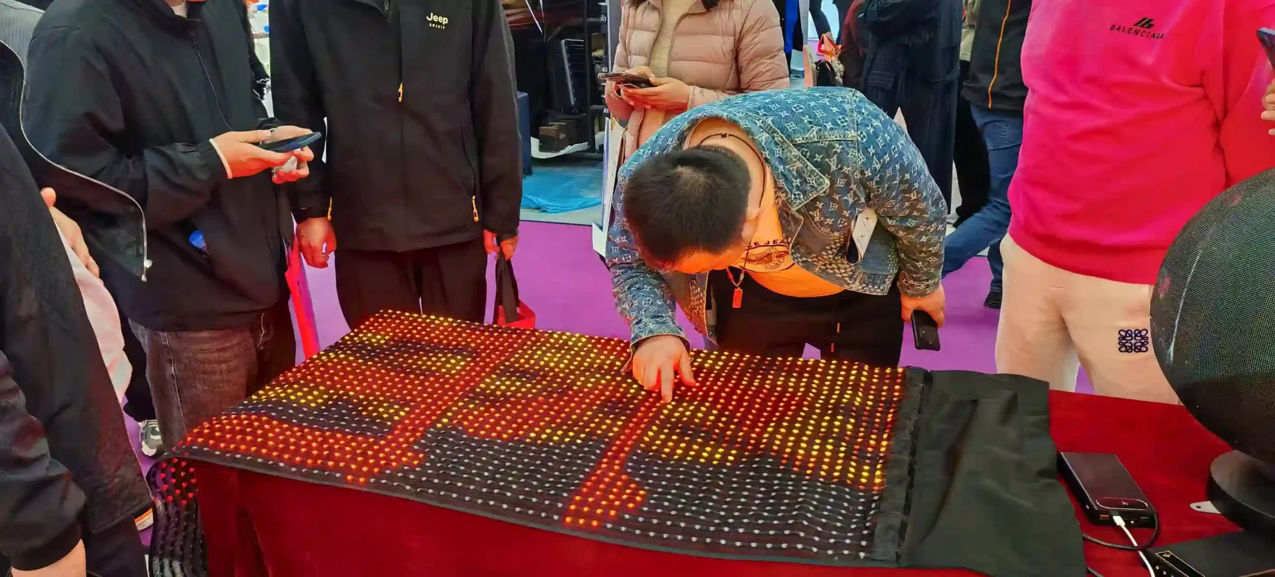 WINFIN LED team demonstrating LED display features at an exhibition