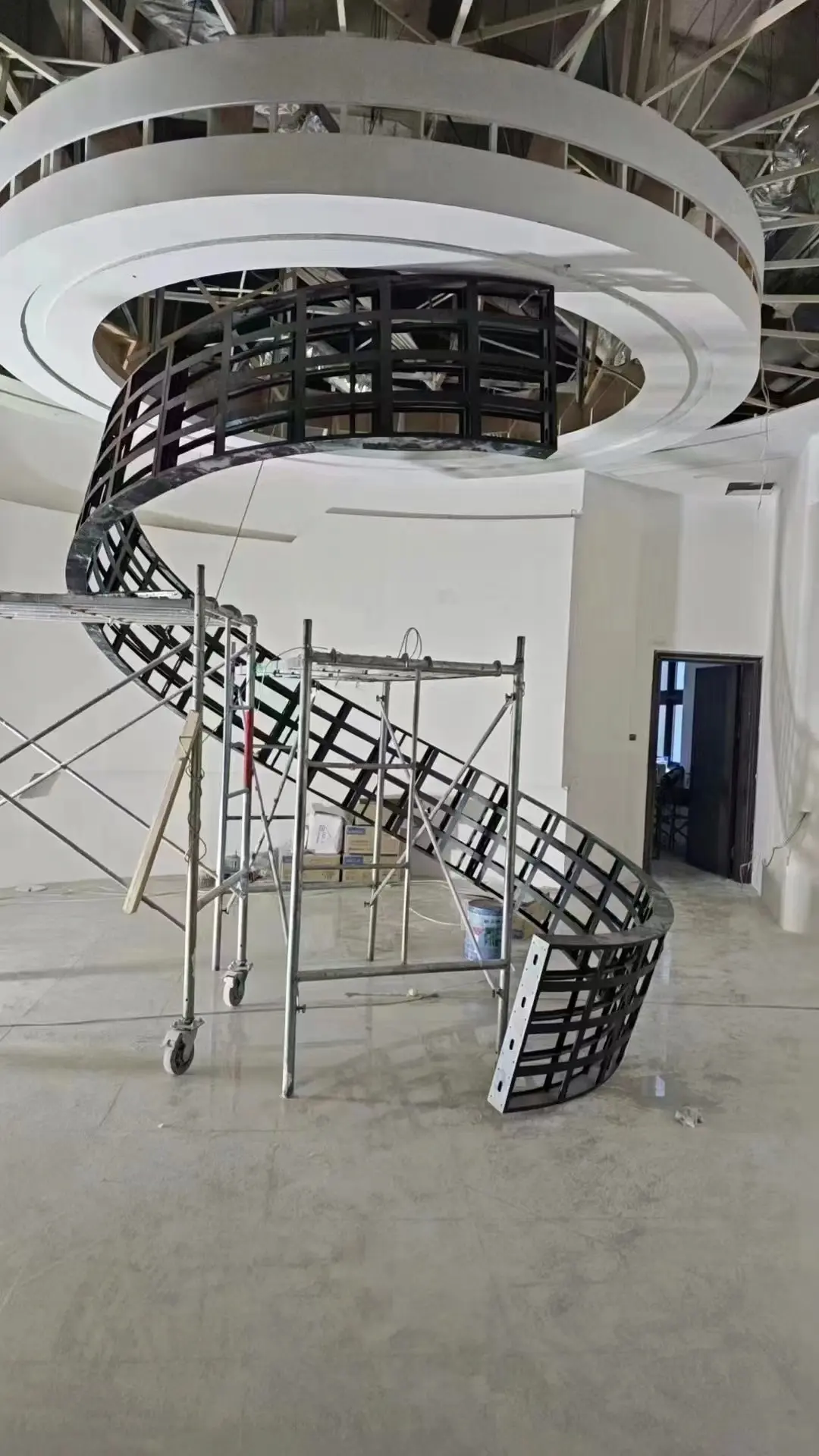 Custom spiral support frame for a flexible LED display during installation