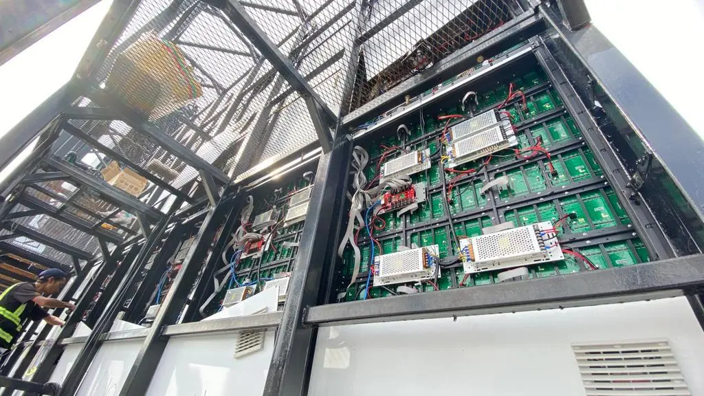 Rear view of open LED billboard cabinets showing power supplies and internal wiring in Malaysia
