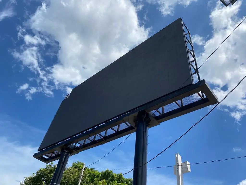 Front view of an outdoor LED billboard mounted on two steel columns in Malaysia, with the screen switched off