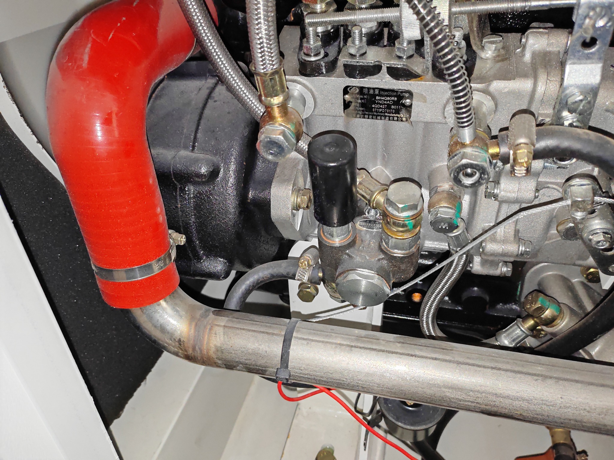 Close-up of the diesel generator engine and fuel injection components inside a mobile LED advertising truck
