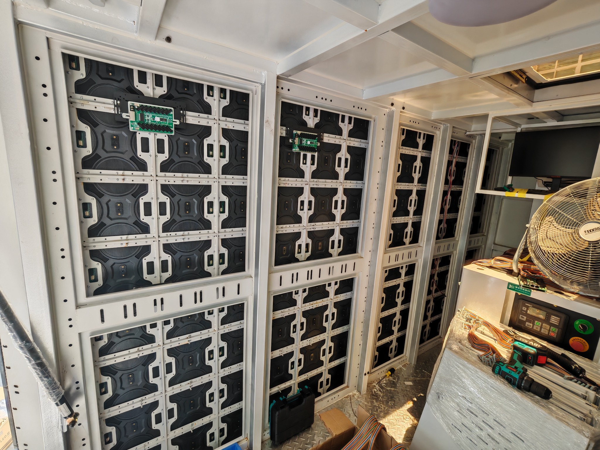 Interior view of outdoor LED display cabinets and module backs inside a mobile advertising truck