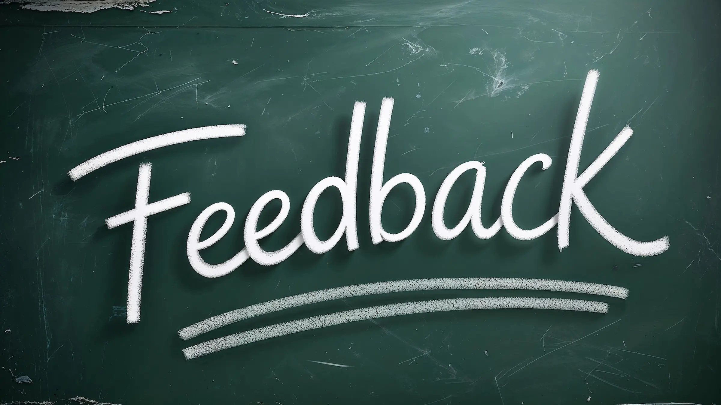 Feedback written in white chalk on a green chalkboard